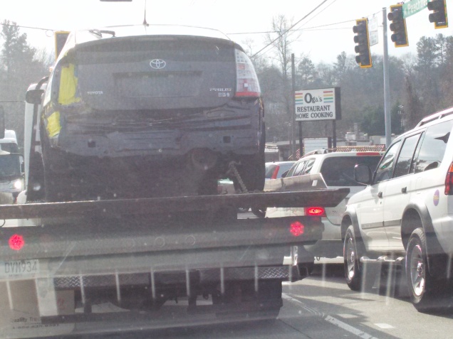 You can just make out exhaust coming out of the tail pipe of this car being towed.  